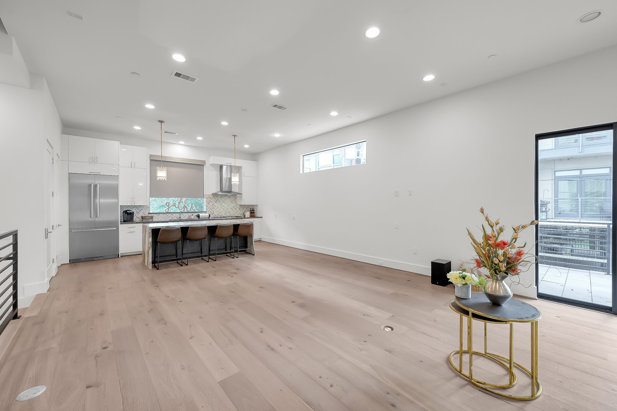 3207 Revere Street Houston, TX 77098 - Photo 25 of 50 a room with stainless steel appliances kitchen island granite countertop white cabinets and wooden floor