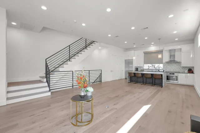 a living room with furniture and kitchen view