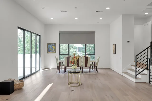 a view of a room with lots of furniture and wooden floor