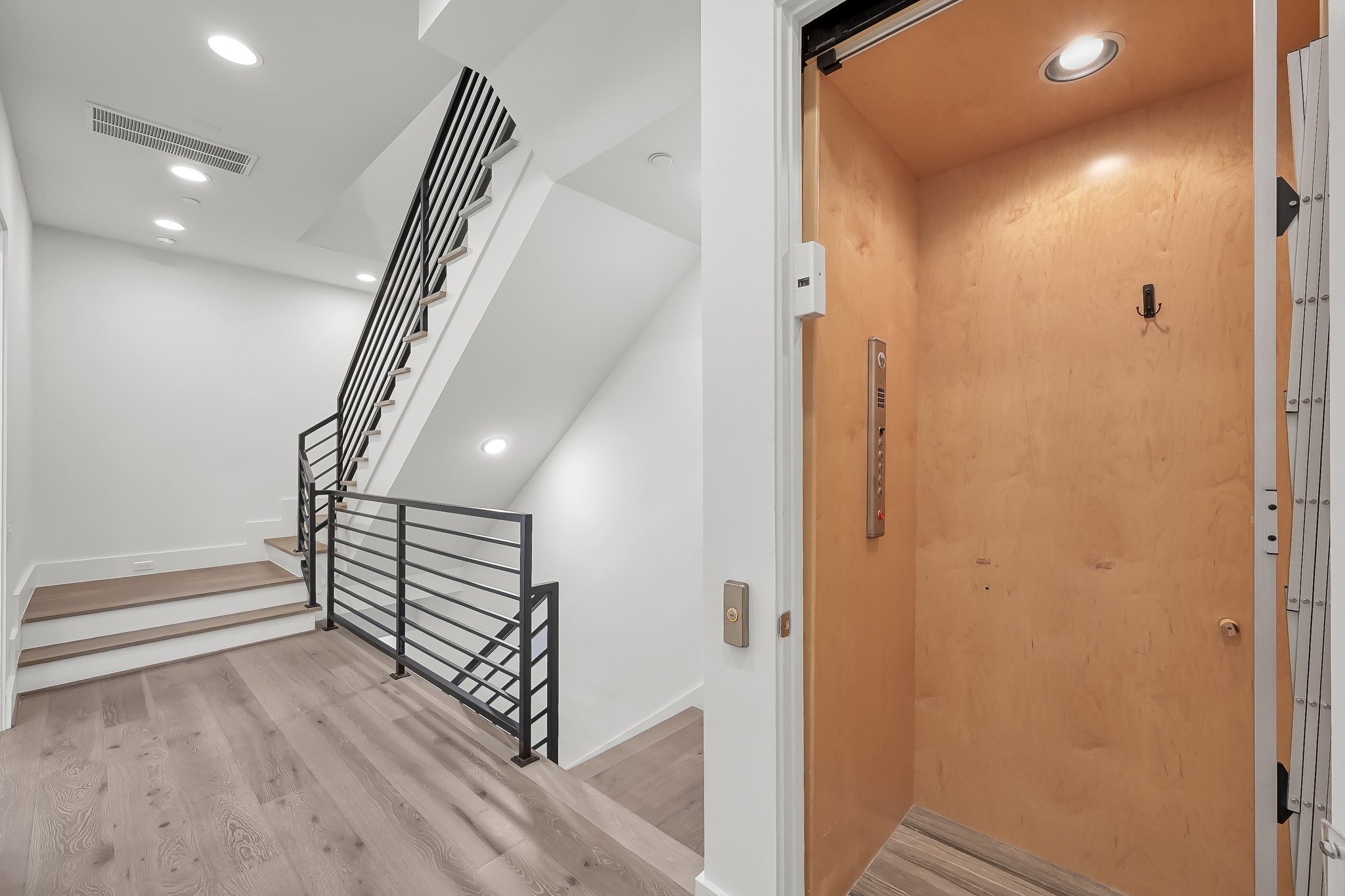 3207 Revere Street Houston, TX 77098 - Photo 33 of 50 a view of a hallway with wooden floor and stairs