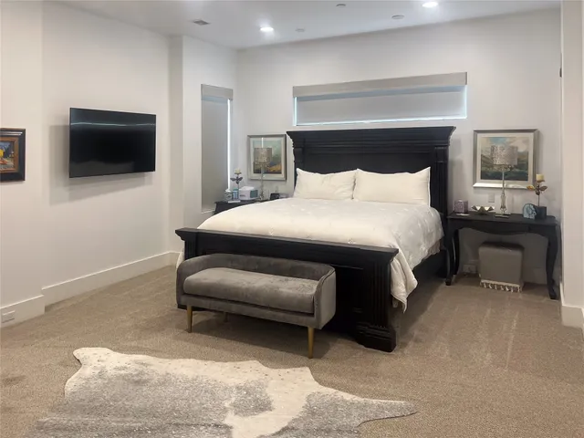 a bedroom with a bed and a television