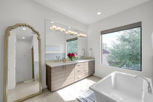 a bathroom with a sink mirror and a bathtub