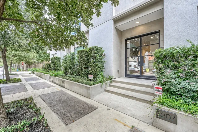 a view of a house with potted plants