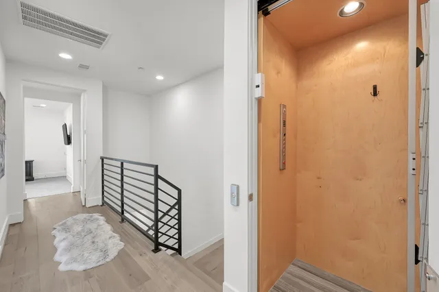 a view of a hallway with entryway door