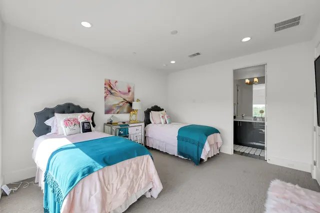 a bedroom with two beds and a couch