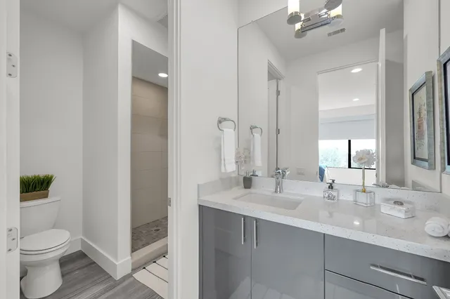 a bathroom with a toilet sink and mirror