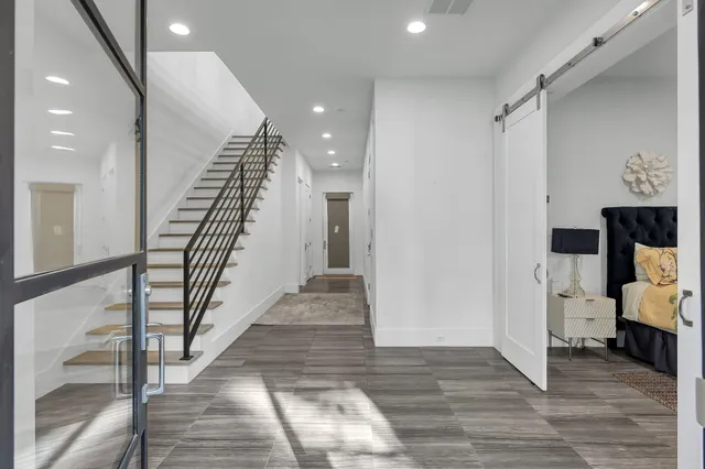 a view of a hallway with wooden floor and staircase