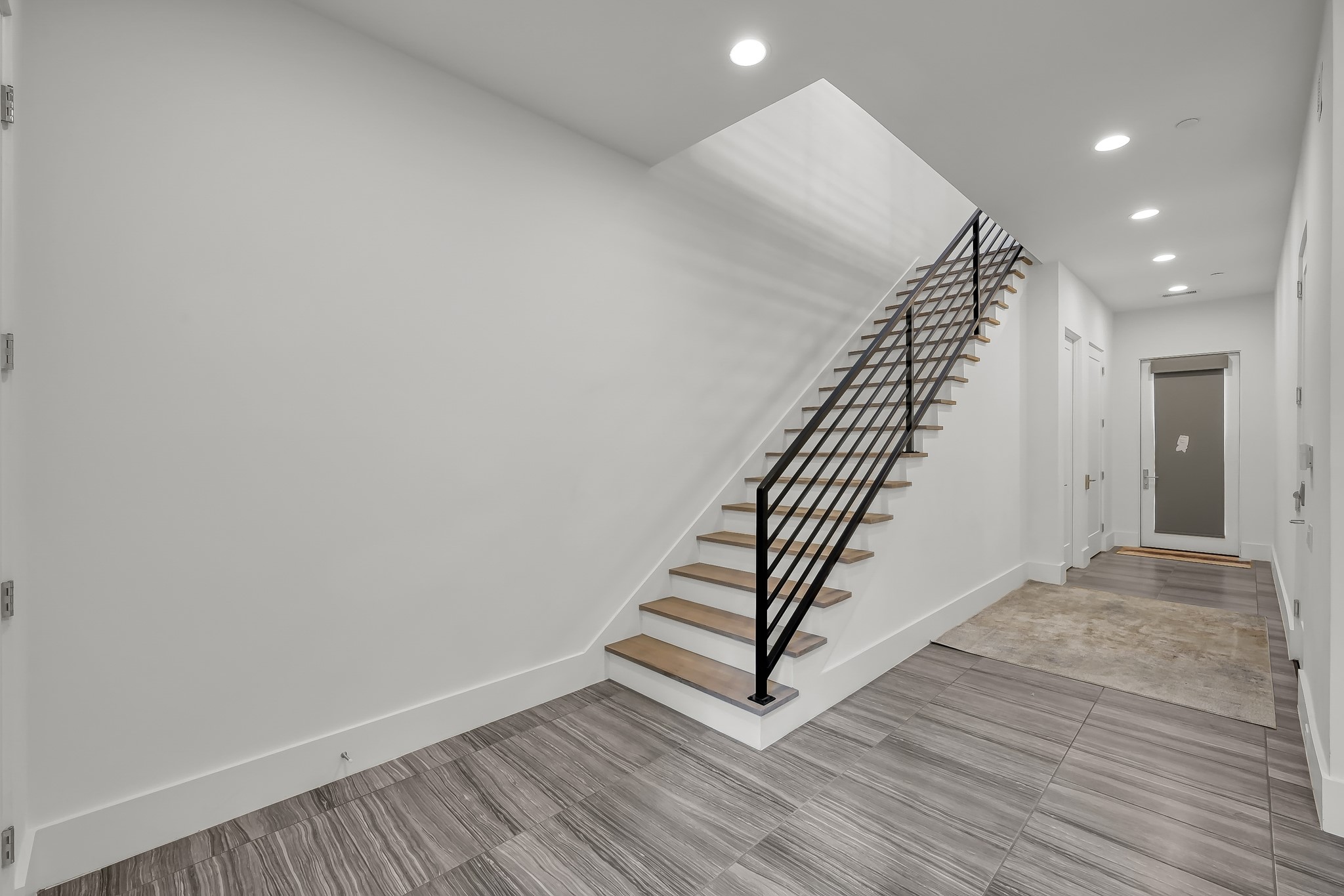 3207 Revere Street Houston, TX 77098 - Photo 8 of 50 a view of a hallway with wooden floor and staircase