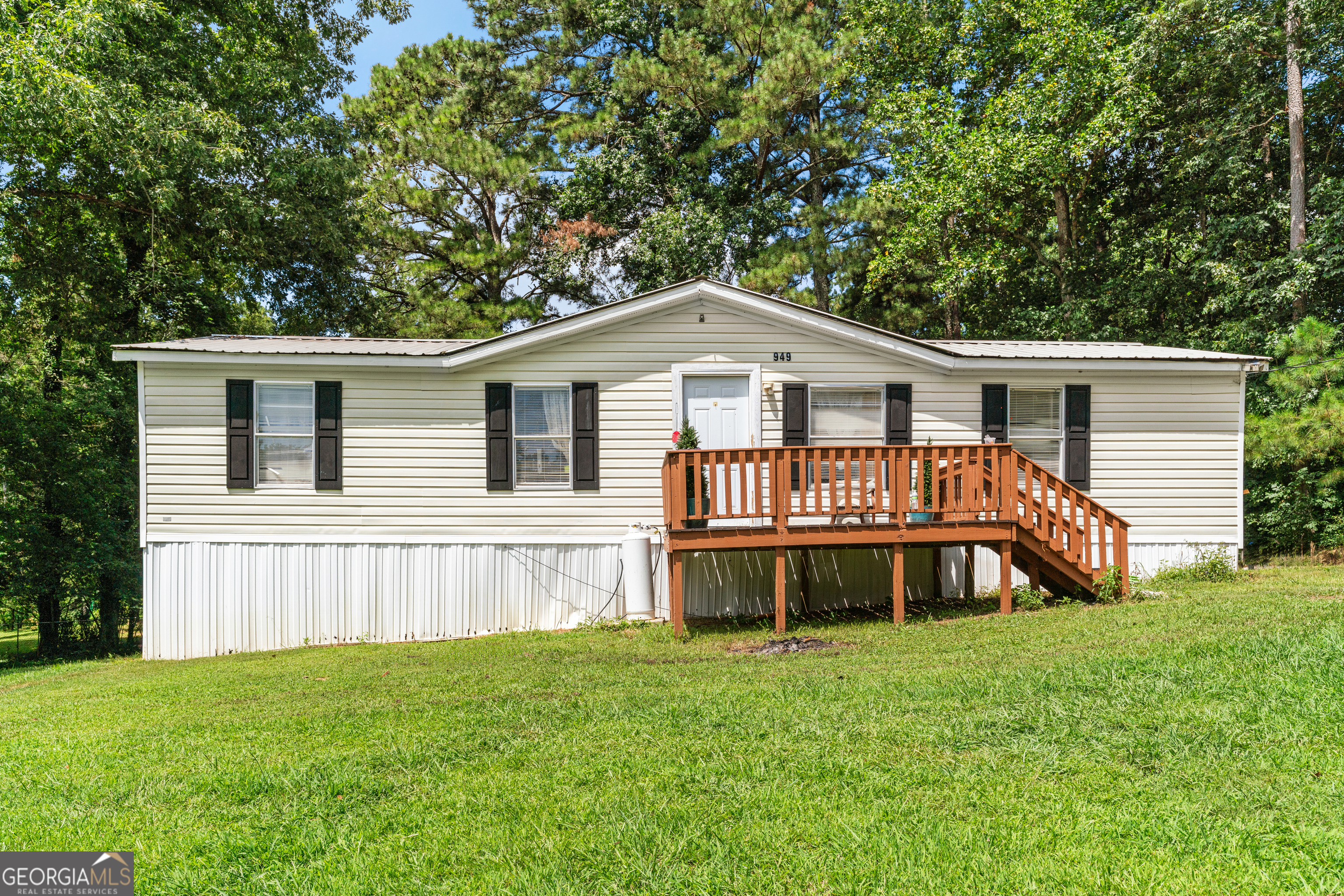 a front view of a house with a garden and deck
