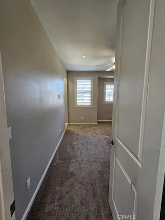 a view of hallway with window and stairs