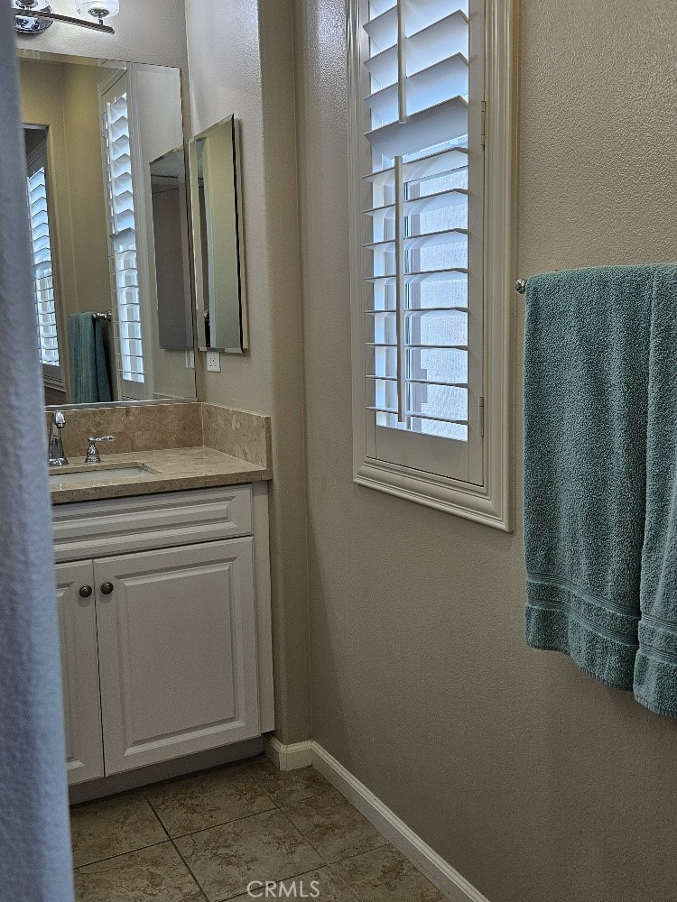 44011 Rivo Court Temecula, CA 92592 - Photo 20 of 34 a bathroom with a sink and a mirror