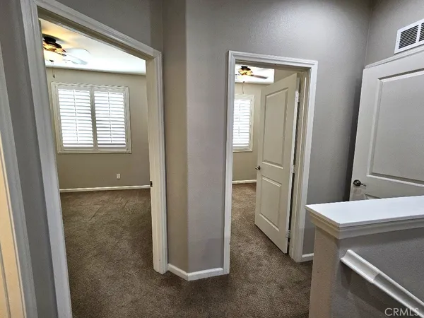 a view of bathroom with a sink cabinet and mirror