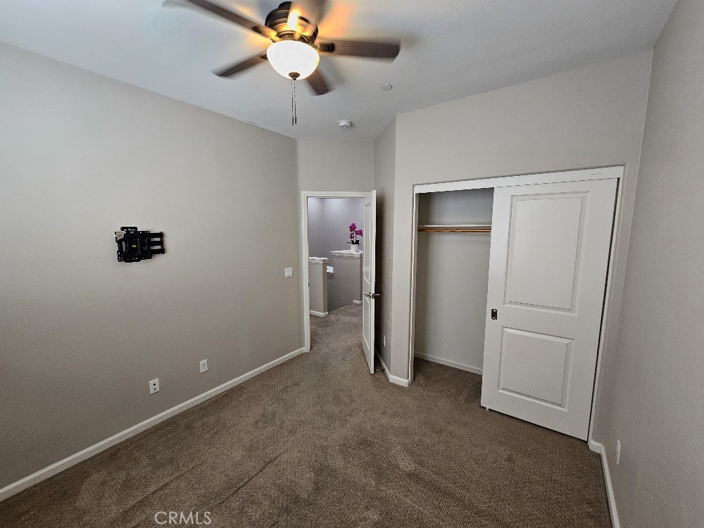 44011 Rivo Court Temecula, CA 92592 - Photo 24 of 34 an empty room with closet and a chandelier fan