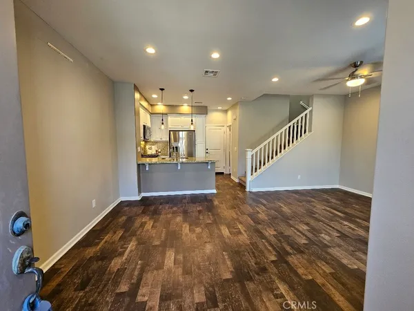 a view of kitchen and hall with wooden floor