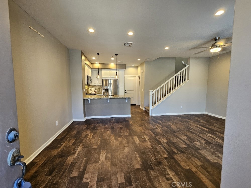 44011 Rivo Court Temecula, CA 92592 - Photo 3 of 34 a view of kitchen and hall with wooden floor