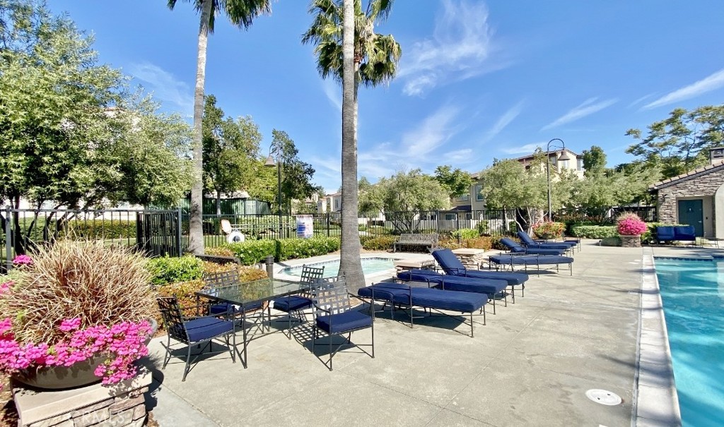 44011 Rivo Court Temecula, CA 92592 - Photo 31 of 34 a view of a patio with couches and table and chairs and potted plants