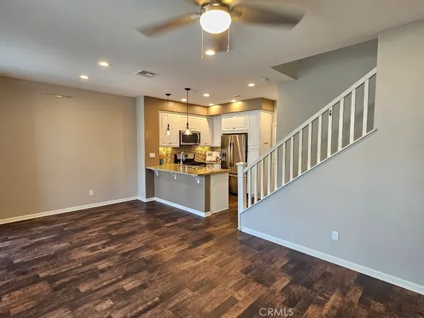 a view of kitchen with kitchen island microwave and stove top oven