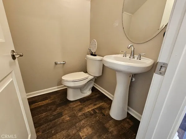 a bathroom with a sink toilet and mirror