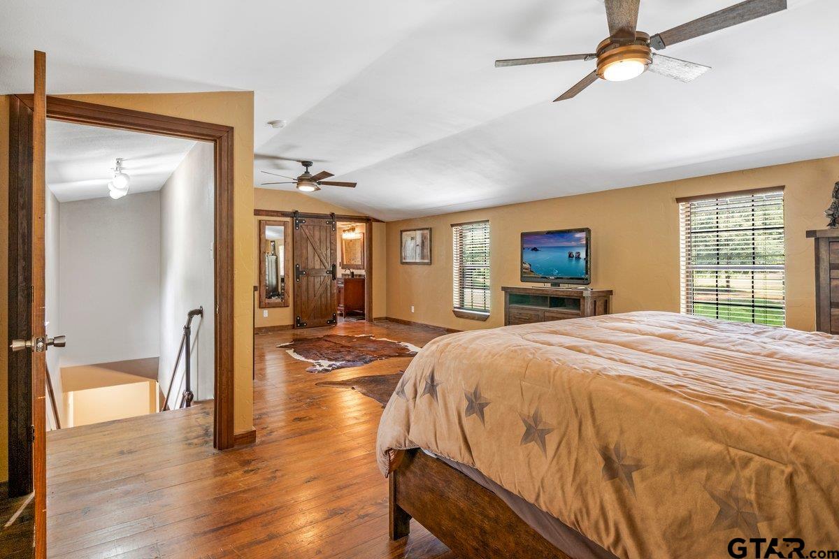 1254 Corinth Road Jacksonville, TX 75766 - Photo 11 of 42 a spacious bedroom with a bed and wooden floor