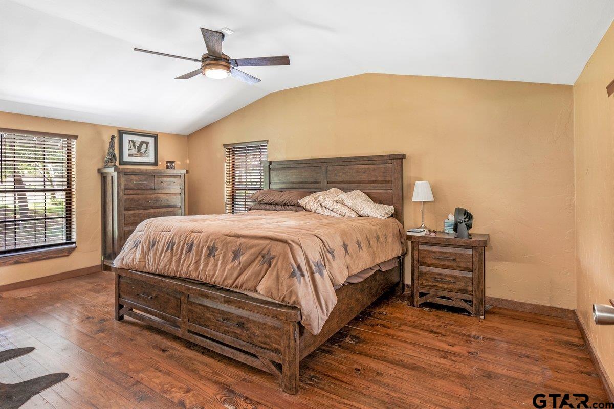 1254 Corinth Road Jacksonville, TX 75766 - Photo 12 of 42 a bed room with a bed and a ceiling fan