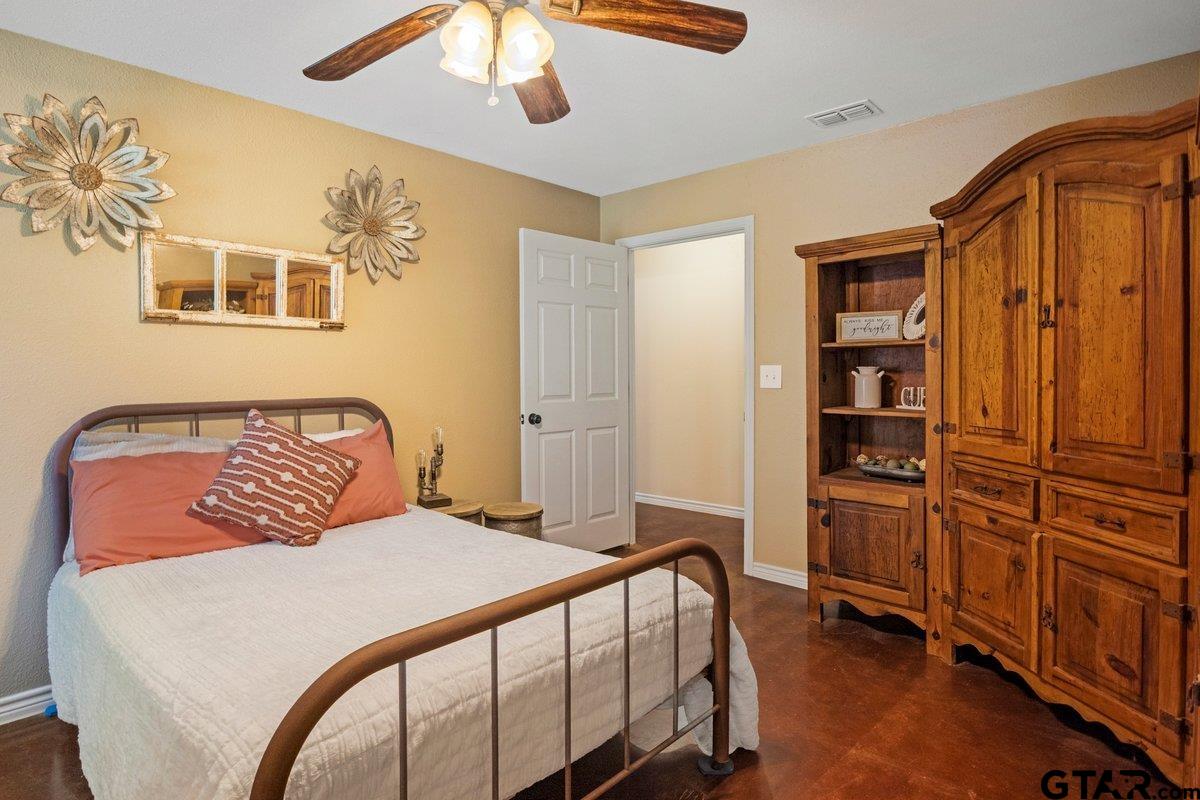 1254 Corinth Road Jacksonville, TX 75766 - Photo 17 of 42 a bedroom with a bed and wooden floor