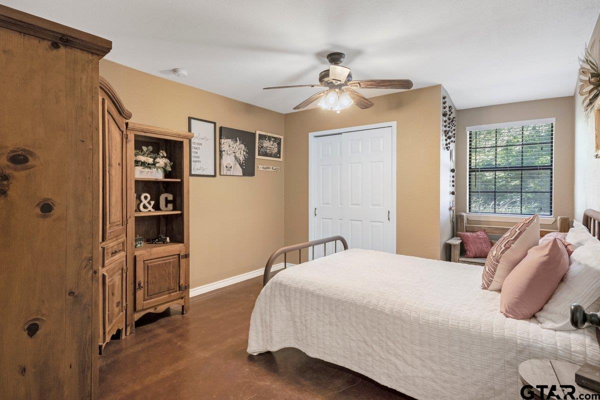 1254 Corinth Road Jacksonville, TX 75766 - Photo 18 of 42 a bedroom with a bed and cabinets