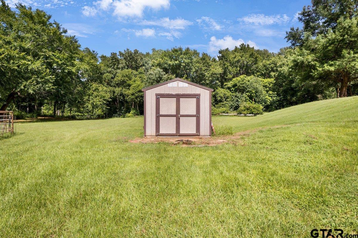 1254 Corinth Road Jacksonville, TX 75766 - Photo 2 of 42 a view of a garden with a house in the background