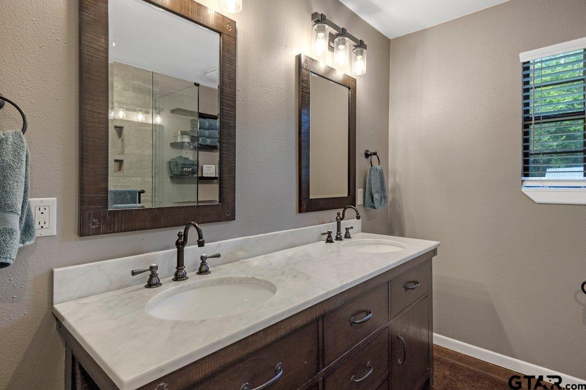 1254 Corinth Road Jacksonville, TX 75766 - Photo 23 of 42 a bathroom with a sink and a mirror