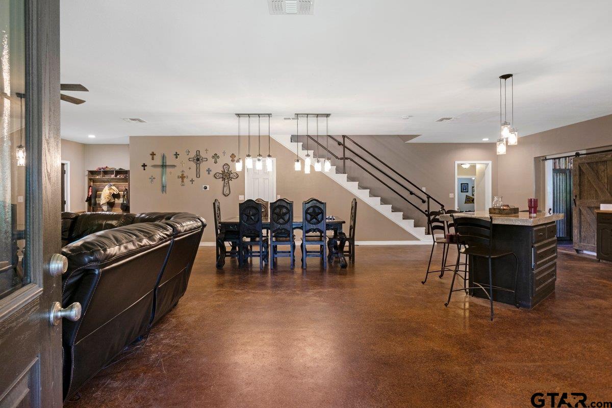 1254 Corinth Road Jacksonville, TX 75766 - Photo 28 of 42 a kitchen with stainless steel appliances kitchen island granite countertop a stove and a refrigerator