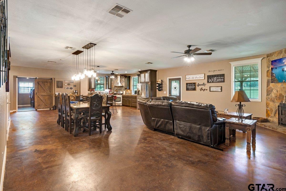 1254 Corinth Road Jacksonville, TX 75766 - Photo 30 of 42 a living room with furniture kitchen view and a dining table