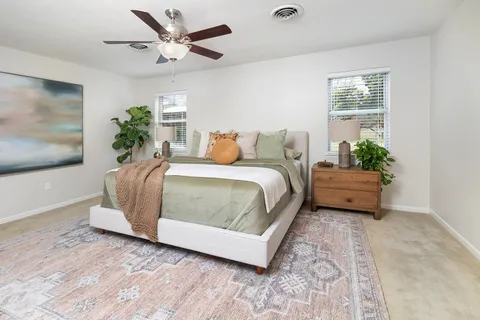 a bedroom with a bed and a potted plant