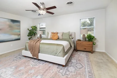 a bedroom with a bed and a couch