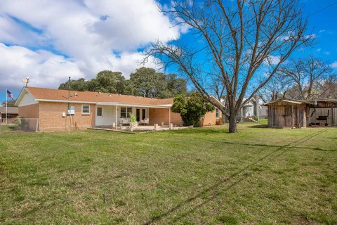 a house that has a tree in front of it