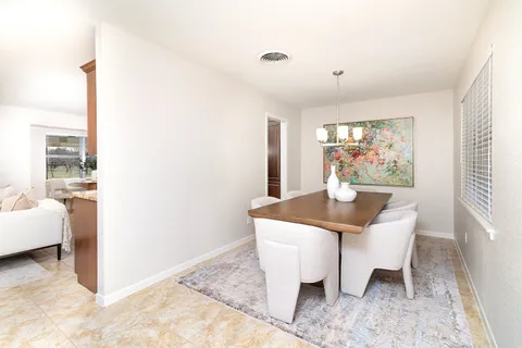 a view of a dining room with furniture and window