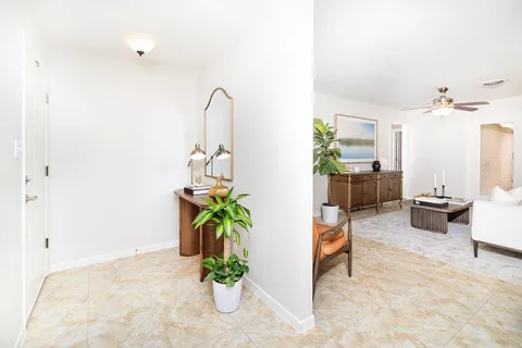 a kitchen with stainless steel appliances granite countertop a sink and a refrigerator