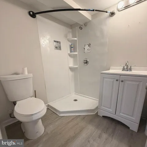 a bathroom with a toilet and a shower