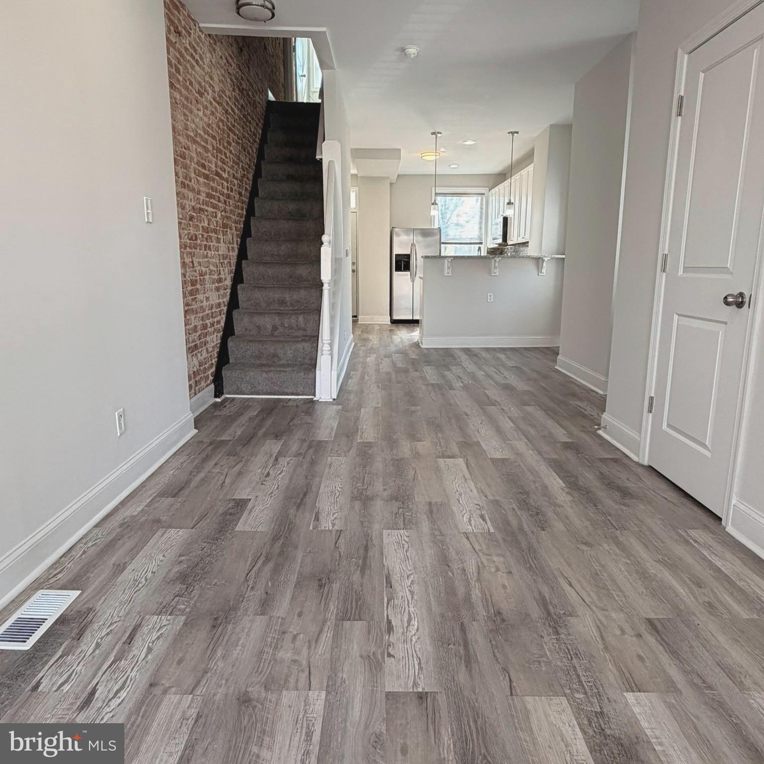 2631 West Cold Spring Lane Baltimore, MD 21215 - Photo 6 of 20 a view of a kitchen with wooden floor and electronic appliances