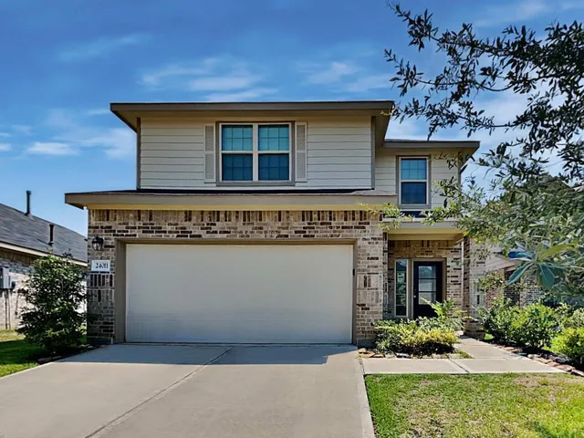 a front view of a house with plants