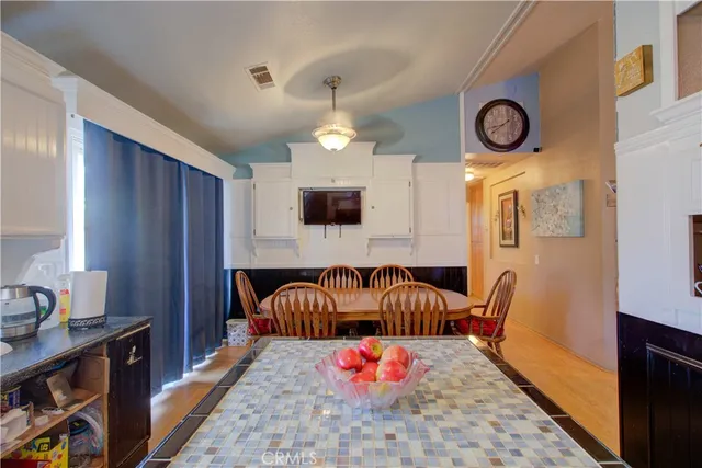 a view of living room kitchen with stainless steel appliances granite countertop furniture and a fireplace