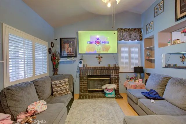 a living room with furniture and a fireplace
