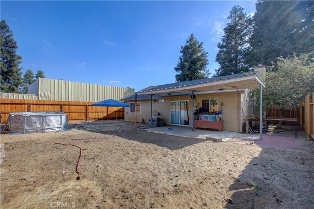 a view of a house with backyard and sitting area