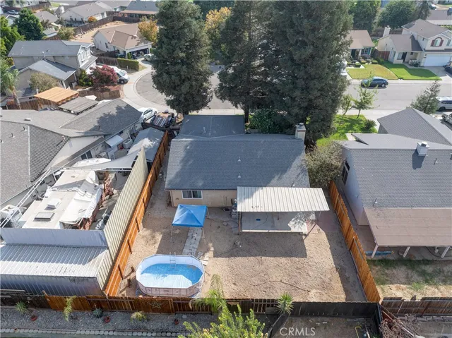 an aerial view of a house with garden space and street view