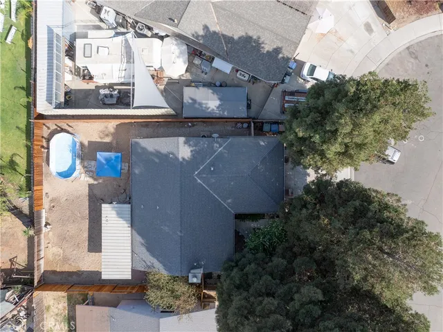 an aerial view of residential houses with outdoor space and parking