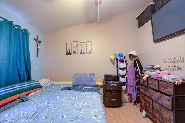 a bedroom with a bed and wooden floor