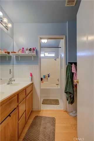 a bathroom with a tub sink and mirror