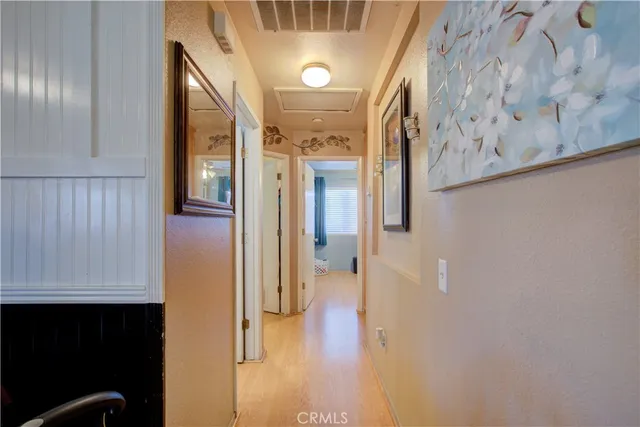 a view of a hallway with wooden floor and staircase