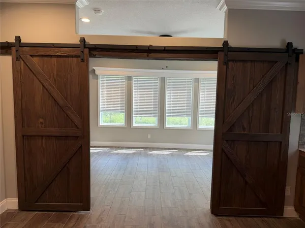 a view of walk in closet with wooden floor