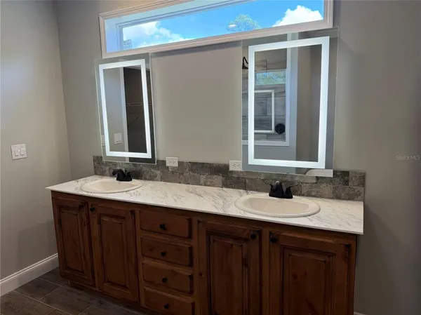 a bathroom with a sink and a mirror