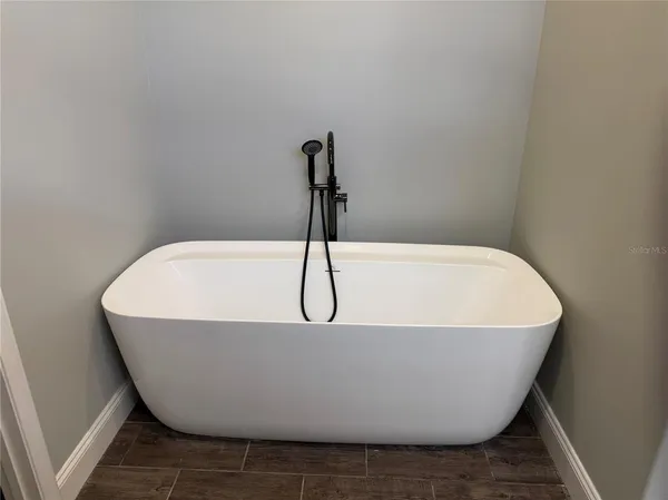 a white tub sitting in a bathroom