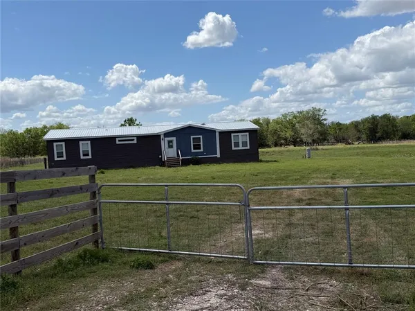 a view of a house with a big yard